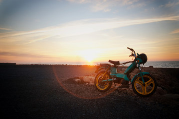 Motorcycle parked by the coast at sunset in Rabat, Morocco