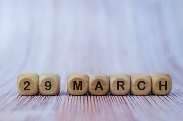 Date March 29, wooden cubes. Days of the month