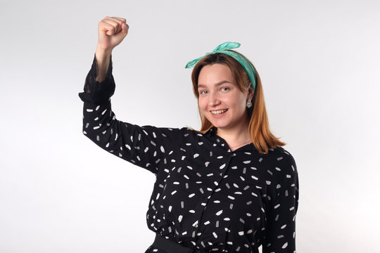 Girl power concept. Young woman showing her arm for feminine and independent strength.