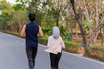 Obraz premium Shallow depth of field with muslim couple running in the park.