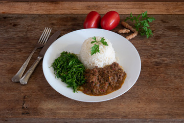 Healthy food dish with beans, rice, cabbage, tomatoes and ginger