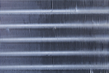 Metal plates on a car radiator in zoom.