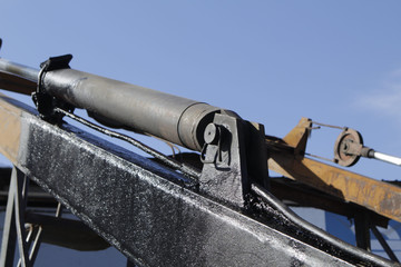 Fototapeta na wymiar Cylinder of the crane boom lifting mechanism of the manipulator.