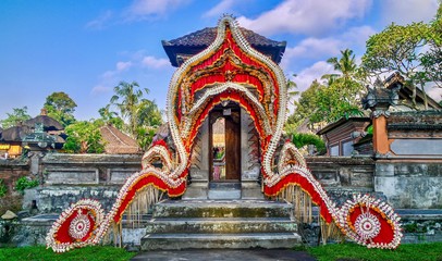 Colorful and festive traditional Balinese wedding decorations at the entrance gate of the bride's family home, near Ubud, Bali.