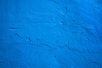 Rough concrete wall texture, bright blue,  vintage rustic grunge backdrop.