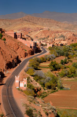 Farmland and red rock hills along road in Dades Gorge in the High Atlas mountains Morocco