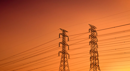 High voltage electric pylon and electrical wire with sunset sky. Electricity poles. Power and...