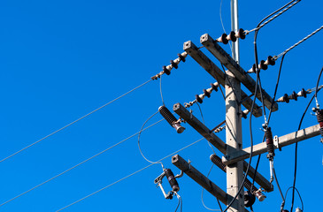 High voltage electric pole and transmission lines with clear blue sky. Electricity pylon. Power and...