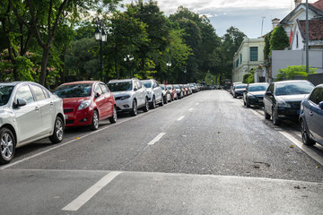 Fototapeta na wymiar Parallel parking cars on urban street. Outdoor parking on road
