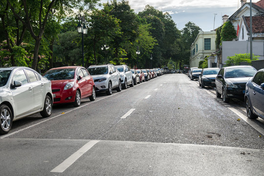 Parallel parking cars on urban street. Outdoor parking on road