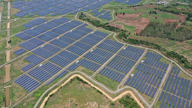 Solar Energy Farm. Aerial View Of A Solar Farm In Asia.