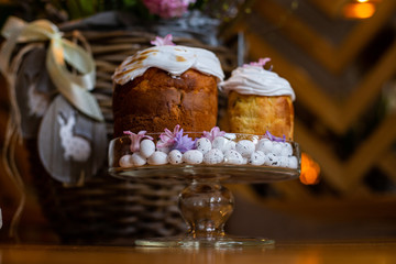 horizontal closeup photo of Easter cakes on a background of a beautifully decorated wicker basket