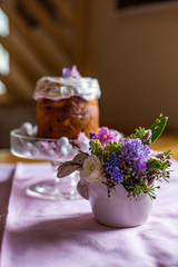 vertical photo of a festive bouquet on the background of Easter cake