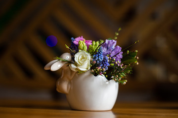 horizontal photo of an easter flower arrangement on a table
