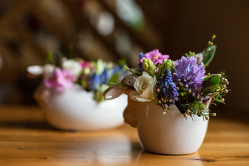 horizontal photo of easter flower arrangements on a table
