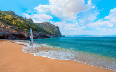 Beautiful surfer woman on the beach at sunny day - Cleopatra beach, Alanya