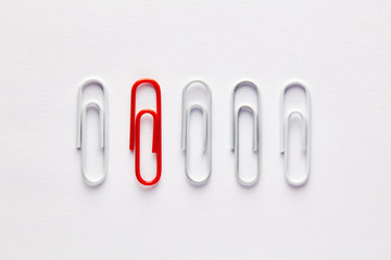 Red paper clip stands out from the crowd