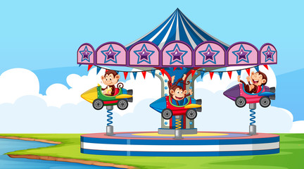 Scene with cute monkeys riding on rocket ride in the park