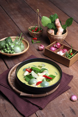 Fototapeta na wymiar Thai food, green curry chicken with coconut curry on a wooden table
