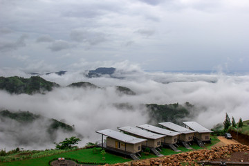 The view of the natural background of the mountain close-up, with blurred fog scattered in the rainy season or the humid climate, with beautiful green trees in the ecological system