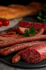 Different tasty sausages on grey table, closeup