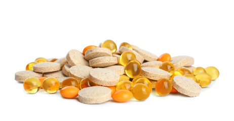 Pile of different vitamin pills isolated on white