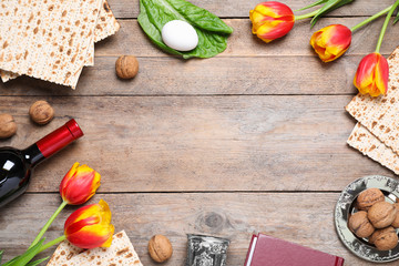 Flat lay composition with symbolic Pesach (Passover Seder) items on wooden table, space for text