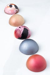 Colorful modern chocolate bonbon truffles on marble