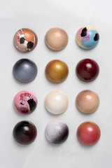 Colorful modern chocolate bonbon truffles on marble