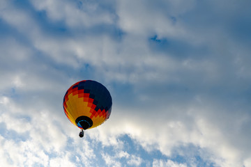 Colorful hot air balloons flying in blue sky. Few colorful, hot air balloons descending at the Balloon Festival.