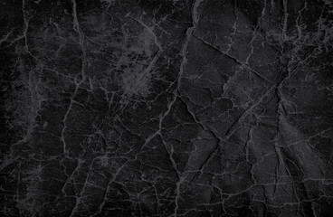 Black crumpled paper texture for background.