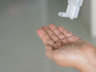 woman squeeze gel tube using a hand wash to prevent germs protect virus covid 19