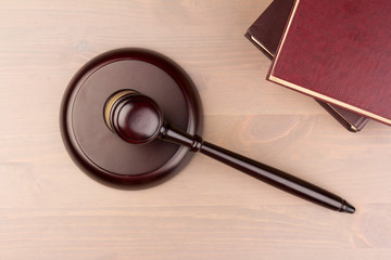 Wooden judges gavel on wooden table, close up. Space for text