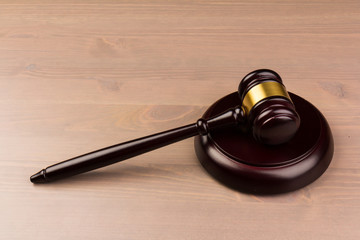 Wooden judges gavel on wooden table, close up. Space for text