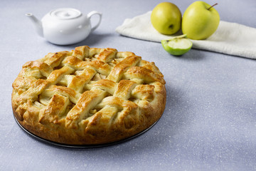 Naklejka na ściany i meble Popular American apple pie on gray table background. Homemade classical fruit tart. Copy space