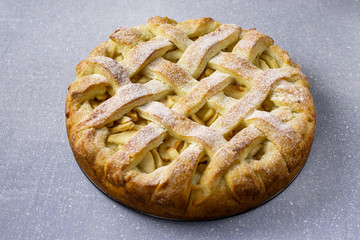 Popular American apple pie on gray table background. Homemade classical fruit tart. Copy space