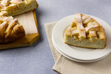Popular American apple pie on gray table background. Homemade classical fruit tart. Copy space