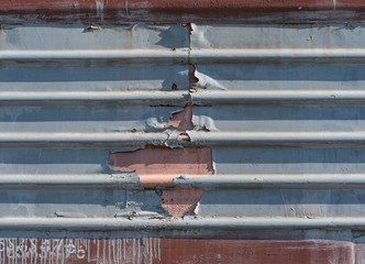 metal fence with damage, metal sheet with horizontal lines, train old metal sheet