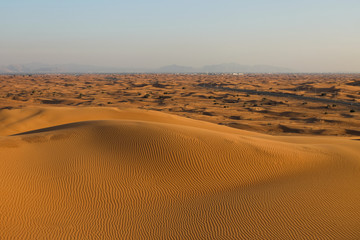 Desert landscape in the RUB al-Khali desert . The texture of sand dunes in the desert is yellow and orange. Red and yellow sand dunes