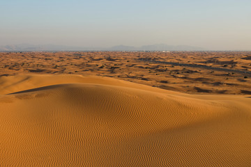 Fototapeta na wymiar Desert landscape in the RUB al-Khali desert . The texture of sand dunes in the desert is yellow and orange. Red and yellow sand dunes