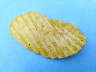 a yellow potato chips eatable food isolated on sky blue background