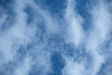 White cloud formation isolated against a bright blue sky image for background use with copy space