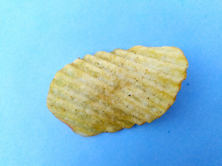 a yellow potato chips eatable food isolated on sky blue background