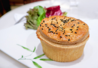 Meat pie on white dish