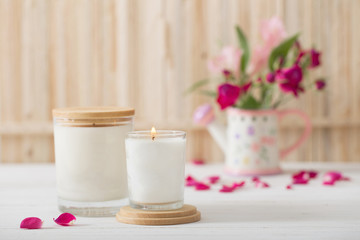 aromatic candles with flowers on wooden background