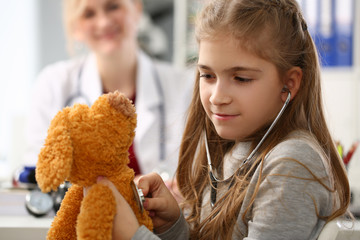 Female hand of little girl hold stethoscope portrait. Listen heart bit concept closeup