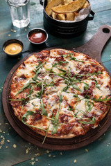 Delicious pizza with salad and fries