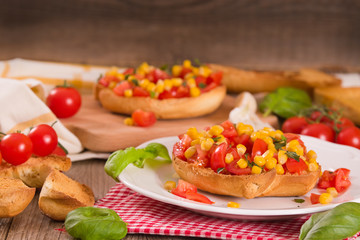 Friselle with tomatoes and mais.	