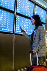 Young woman at international airport moving to terminal gate for airplane travel trip - Mobility concept and aerospace industry flight connections