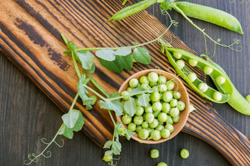 young fresh green peas on a wooden Board. new crop